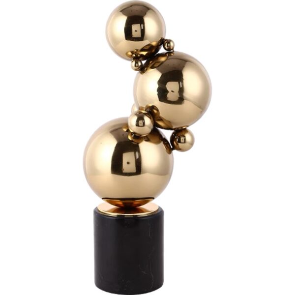 Steel ball sculpture plated in gold on marble